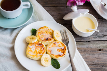 curd cheese pancakes with banana, condensed milk and fresh mint,