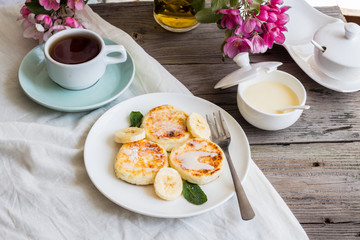 curd cheese pancakes with banana, condensed milk and fresh mint,