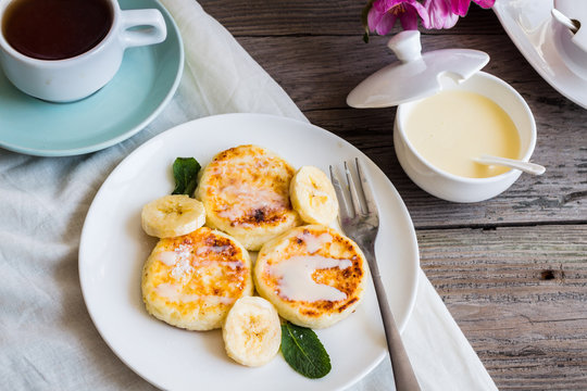 curd cheese pancakes with banana, condensed milk and fresh mint,