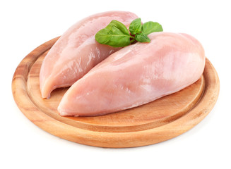 Raw chicken fillets on wooden board isolated on white - obrazy, fototapety, plakaty