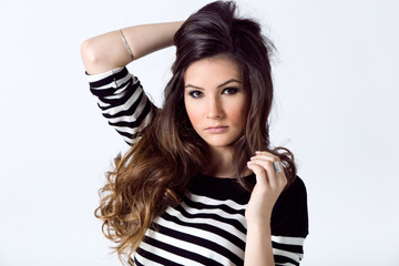 Fototapeta premium Fashion portrait of pretty young woman posing in the studio photo.