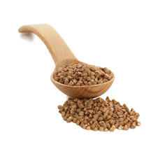 Buckwheat in wooden spoon on white.