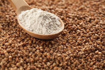Wooden spoon with buckwheat flour.