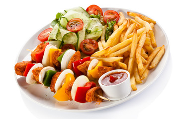 Grilled meat, chips and vegetables 