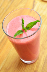 berry milkshake in glasswith mint, top view, close-up