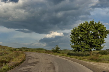Naklejka premium Beautiful picturesque road in the mountain with cloudy sky, Bulgaria.