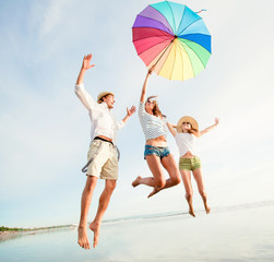 Group of happy young people having fun on the beach