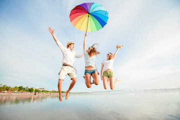Group of happy young people having fun on the beach