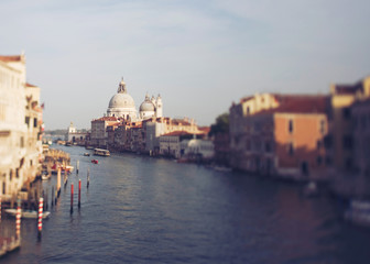 Fototapeta na wymiar Vintage photo of Grand canal of Venice in tilt shift. Church Santa Maria della Salute