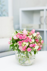Beautiful small bouquet with roses in glass vase