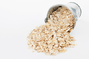 Oat flakes  spilling out of bucket