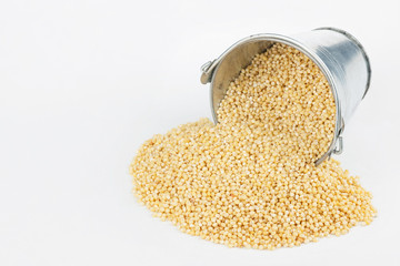 Millet grains spilling out of bucket