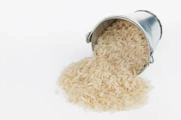Poster Rice grains spilling out of bucket © alekleks