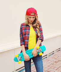 Fashion portrait of pretty cool girl in red cap, checkered hipst
