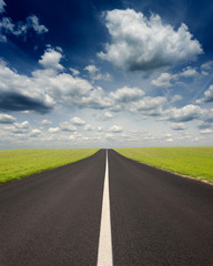 Fototapeta premium Driving uphill on an empty road at idyllic sunny day