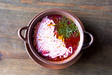 soup with sour cream in a clay pot