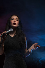 Beautiful female singer in studio