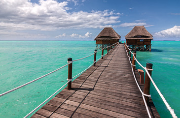 wooden jetty to ocean huts
