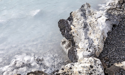 Rocks and warm waters rich in minerals like silica and sulfur in the Blue Lagoon near Reykjavik, Iceland.
