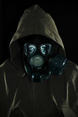 Man in chemical protection suit with a hood and mask