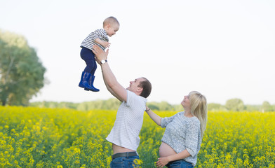 family from three people on a rape field