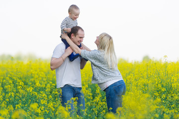 family from three people on a rape field
