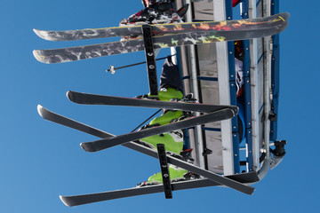 Skiers on chairlift in mountain