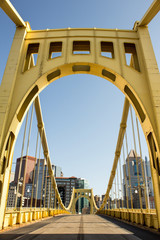 Yellow Bridge Center - Yellow Painted Iron Bridge and Empty Road Leads Into a City of Tall Buildings - obrazy, fototapety, plakaty