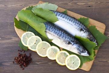 Fresh mackerel in grape leaves with lemon slices