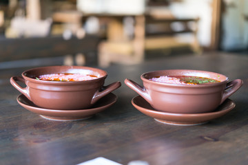 soup with sour cream in a clay pot