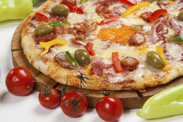 Pizza with several kinds of meat products, mushrooms and cheese served on a table.