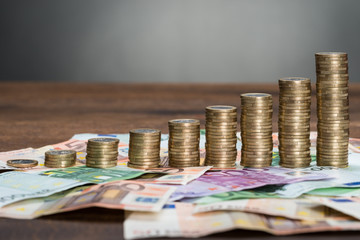 Stacked Coins Arranged On Banknotes