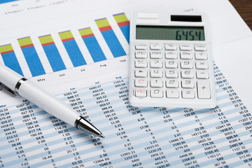 Naklejka na ściany i meble Financial Data Sheet With Calculator And Pen