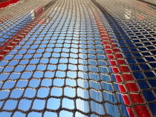 Behind the safety net of the ship is the sea