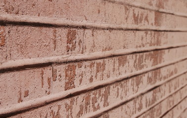Old empty brick wall background, plaster falling off