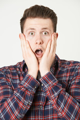 Studio Portrait Of Man With Shocked Expression