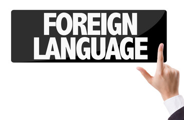Businessman pressing button with the text: Foreign Language