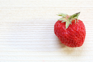 One Strawberry on wooden board