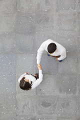 Top view of businesspeople shaking hands outdoors
