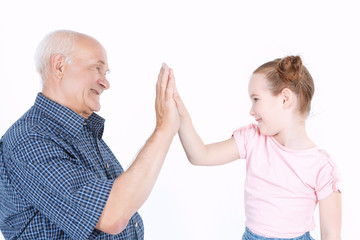 Grandfather having fun with his granddaughter