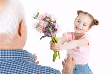 Grandfather having fun with his granddaughter