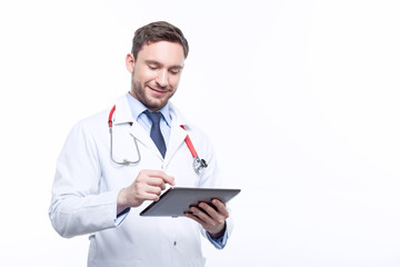 Handsome doctor holding the laptop