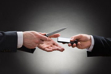 Businessmen Hands With Knife And Mobile Phone