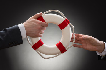 Close-up Of A Male's Hand Holding Lifebuoy