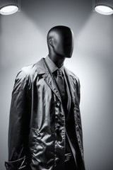Fashion mannequin in suit over dark grey background. Black White photo