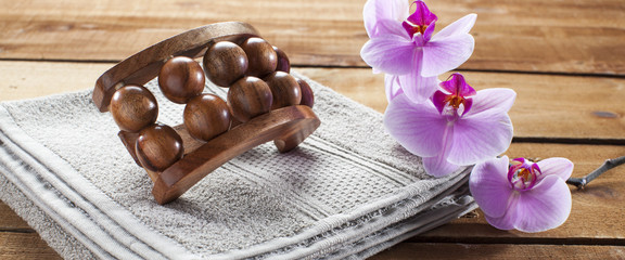 concept of massage and washing-up with towel, wooden accessory and orchid flowers for wellbeing
