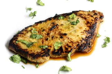 delicios isolated tuna steak with greenery
