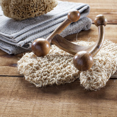Fototapeta na wymiar concept of massage and washing-up with loofah glove, wooden accessory and towel for wellness