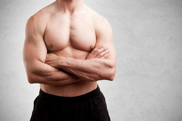 Obraz premium Fit Man Standing With Arms Crossed