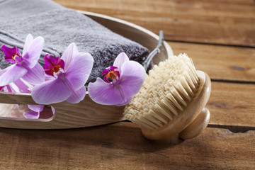 Obraz na płótnie Canvas beauty ritual for spa treatment with natural sponge, towel, brush, flowers and massage accessory